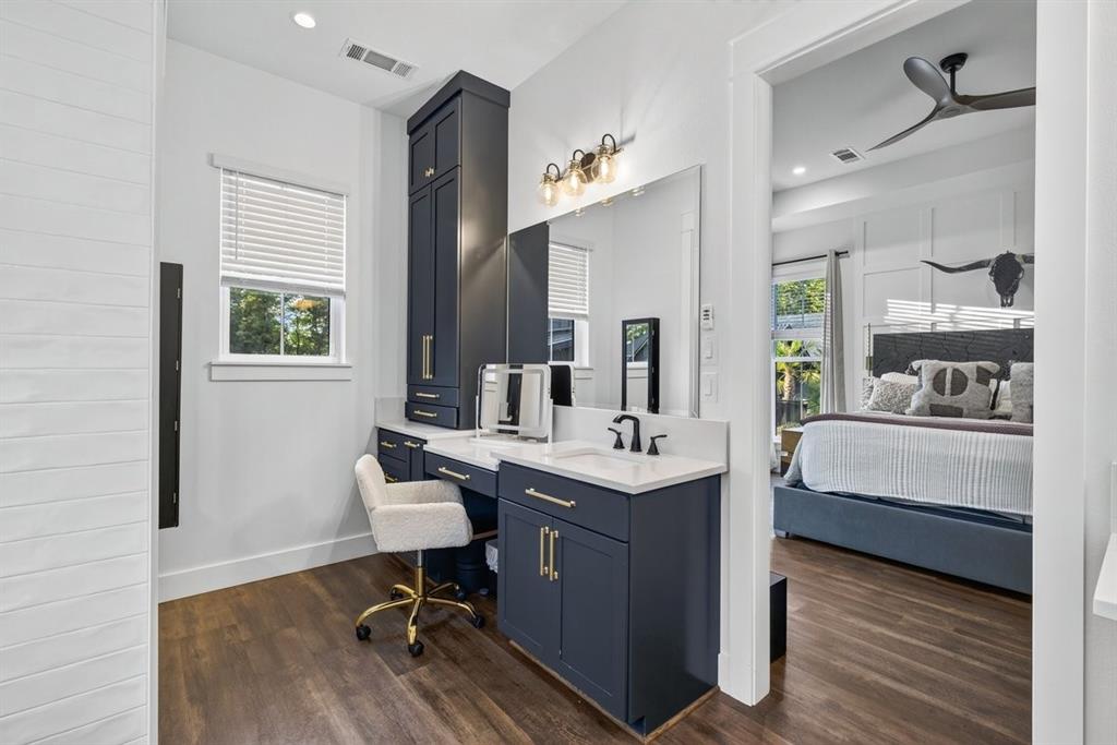Dedicated makeup vanity with custom cabinetry, ample storage, and generous countertop space. Main Residence.