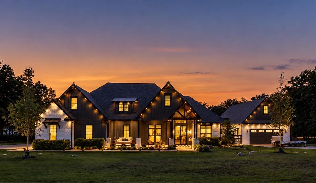 Beautiful twilight view of the main residence, showcasing the exterior architecture and landscape lighting.