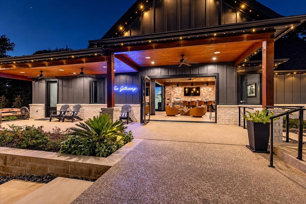 Detached 2,300 SF entertainment lounge, known as the Getaway, with accordion-style glass doors opening to the outdoor patio.