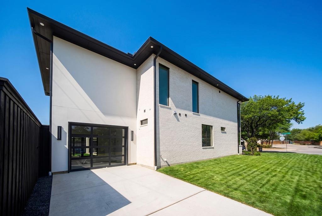 Appreciate the convenience of a dedicated side-entry driveway, and the 3rd car garage, that keeps vehicle access smooth and discrete alongside a lush green lawn