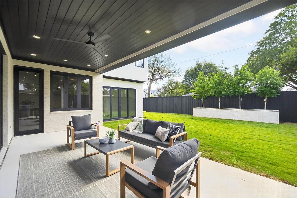 Host weekend barbecues on the patio under the tongue and groove wood ceiling