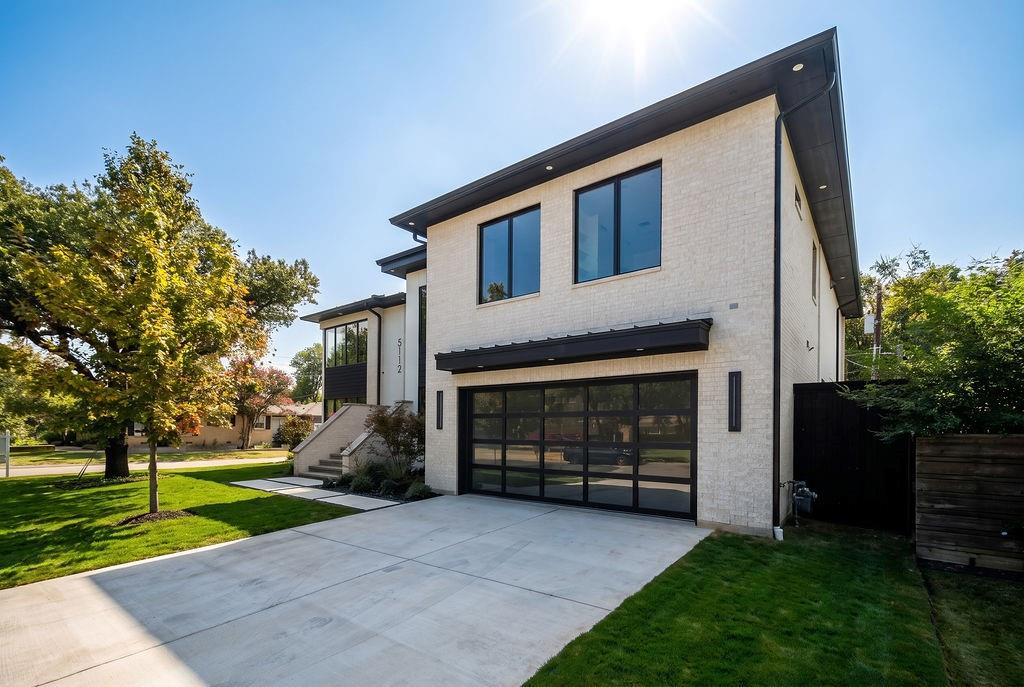 Pull seamlessly into your expansive 2-car, front facing garage after a day around town, with a concrete driveway that makes unloading groceries and parking effortless