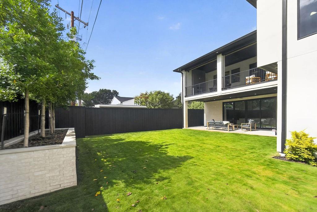 Savor outdoor living in the Bird Streets from your multi-level backyard setup, complete with upper balcony lounging and a lower covered patio