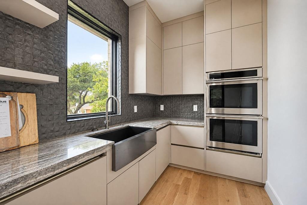 Keep party prep organized and out of sight with extra oven capacity, a dedicated sink, and custom wall cabinets
