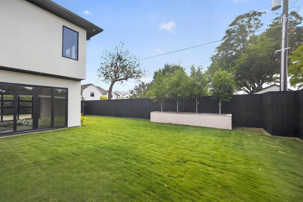 Let pets run freely or play lawn games on the green, low-maintenance yard enclosed by privacy fencing