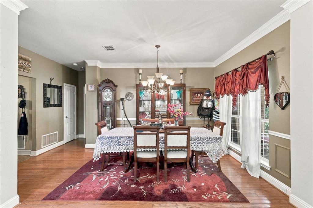 Formal dining room alongside entryway leading into the kitchen.