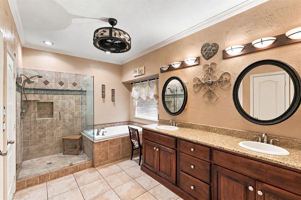 Primary Bathroom with walk-in shower, soaking tub, double vanity countertop.