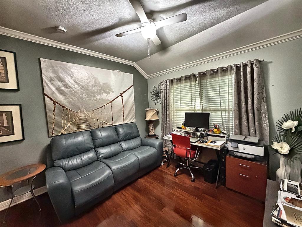 Vaulted ceilings, wood-finish flooring, and a ceiling fan with integrated lighting