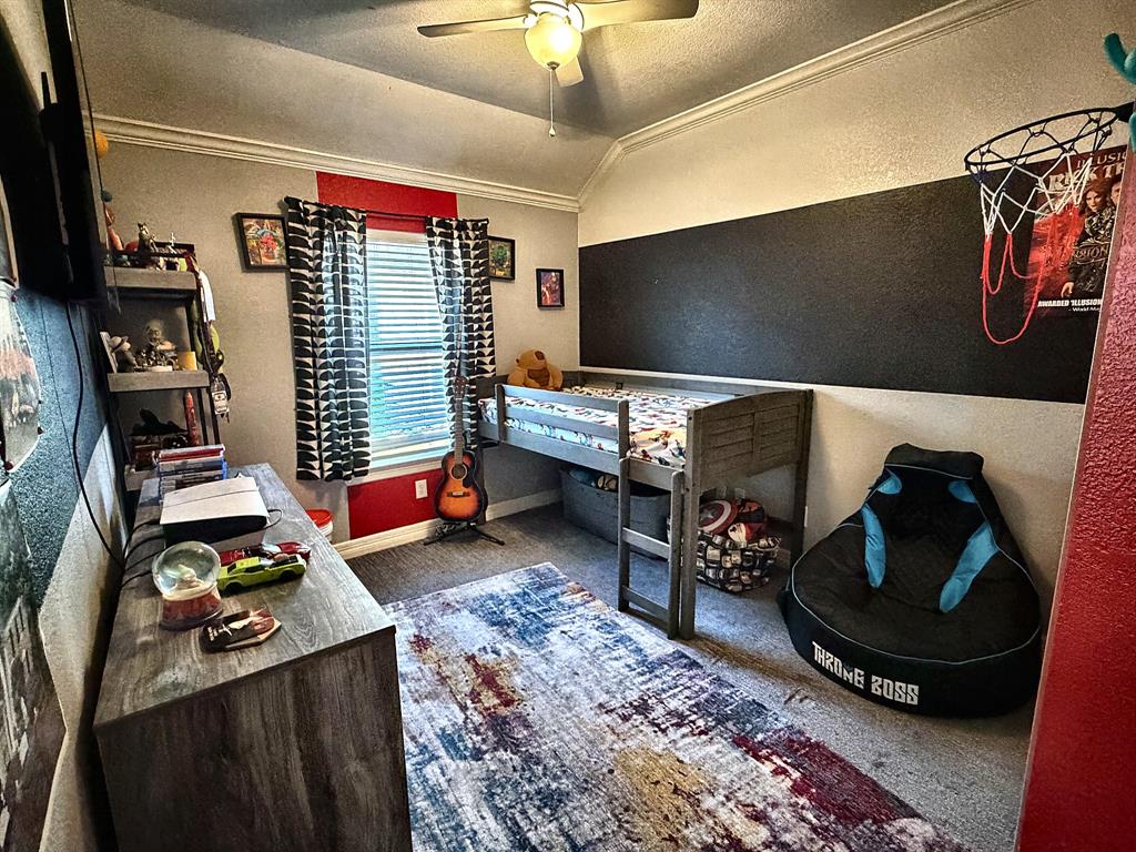 Vaulted ceiling featuring a central light fixture with an integrated ceiling fan and multi-tone wall paint