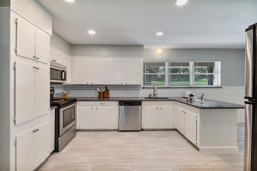The kitchen has granite counters and stainless appliances