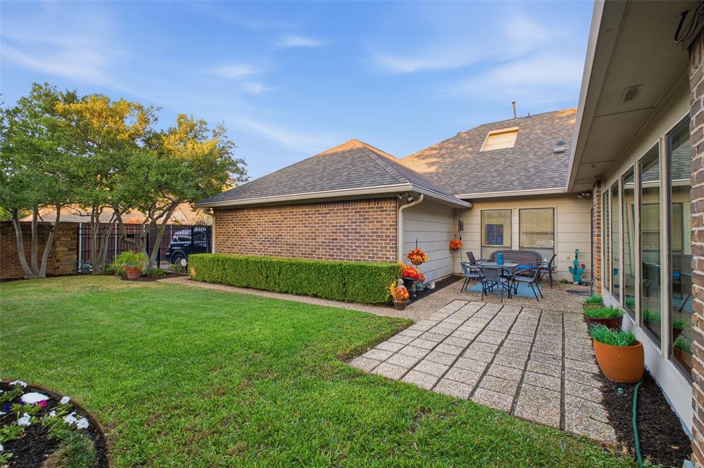 Lush lawn, manicured hedges, and a patio right off the living room—room to garden, play, and unwind.