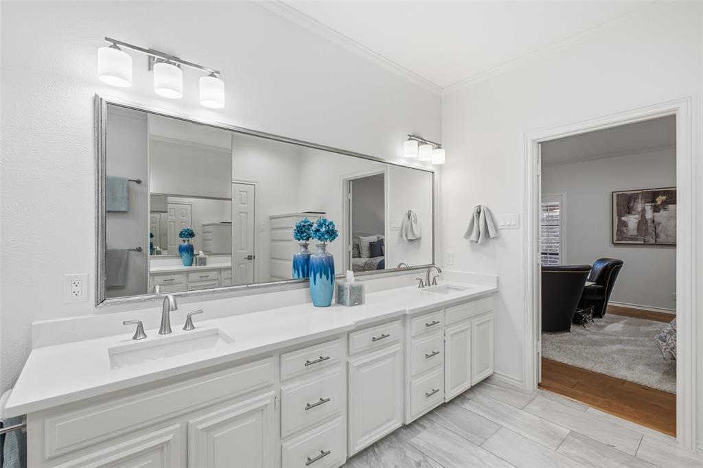 Dual vanity with quartz countertops and abundant drawer storage, steps from the primary bedroom.