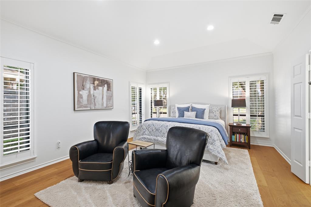 Your primary retreat: plantation shutters, wide-plank wood floors, and room for a cozy sitting area.