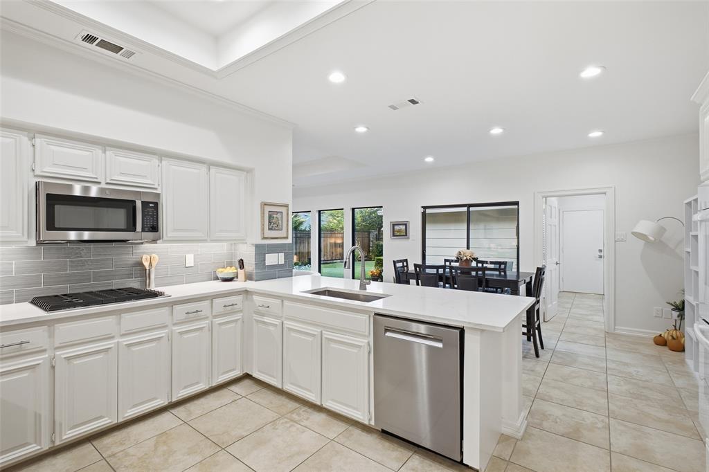 Gas cooktop, stainless dishwasher and built-in microwave, plus views to the backyard while you cook.