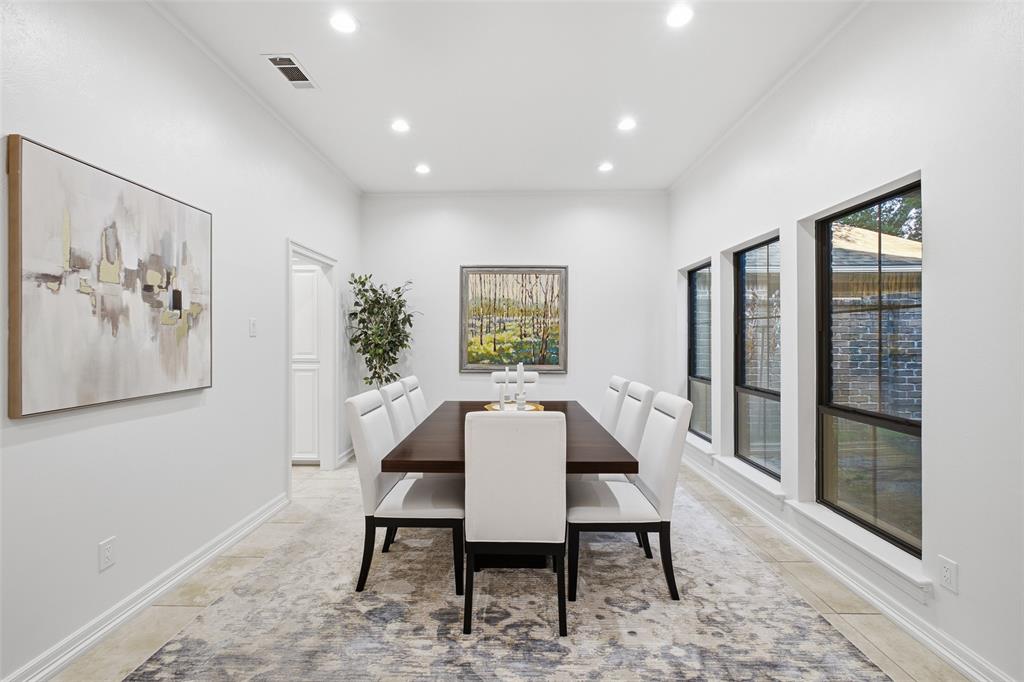A soaring ceiling and wall of windows fill the dining room with natural light. Made for lingering over dinner.