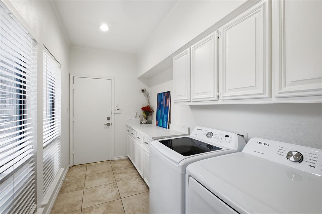 Utility room with built-in cabinets and counter space, with direct access to the garage.