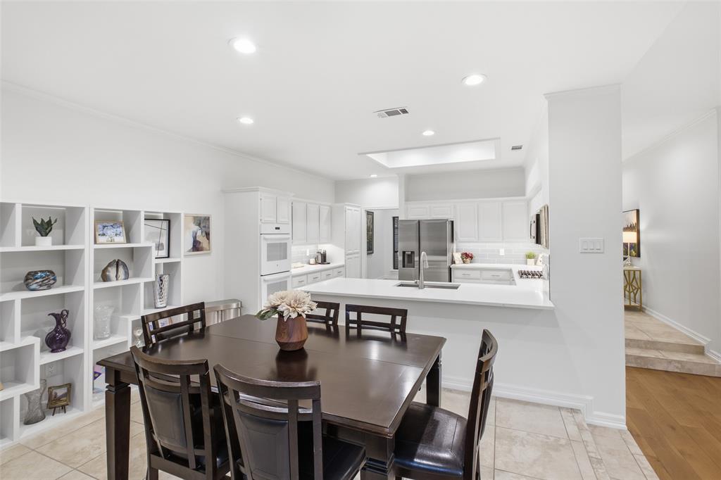 Built-in shelving, a sunny nook, and the kitchen steps away make weeknight dinners feel easy.