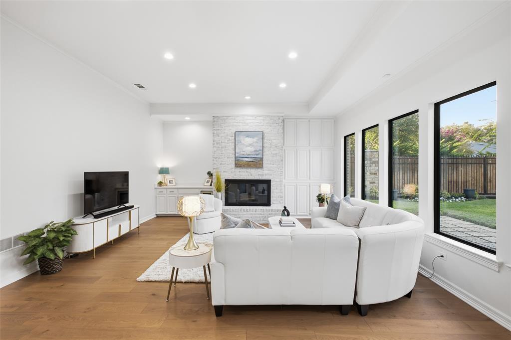 Soaring ceilings and walls of glass frame the backyard greenery—movie nights and lazy Sundays have a new home.