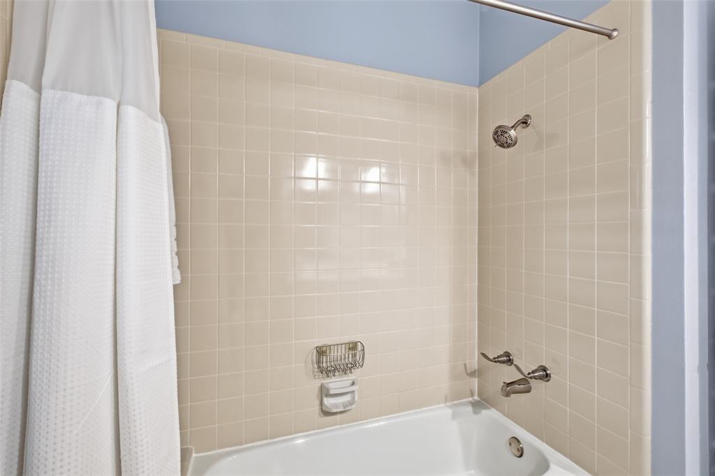 Tub/shower combo in the hall bath, conveniently shared by the secondary bedrooms.