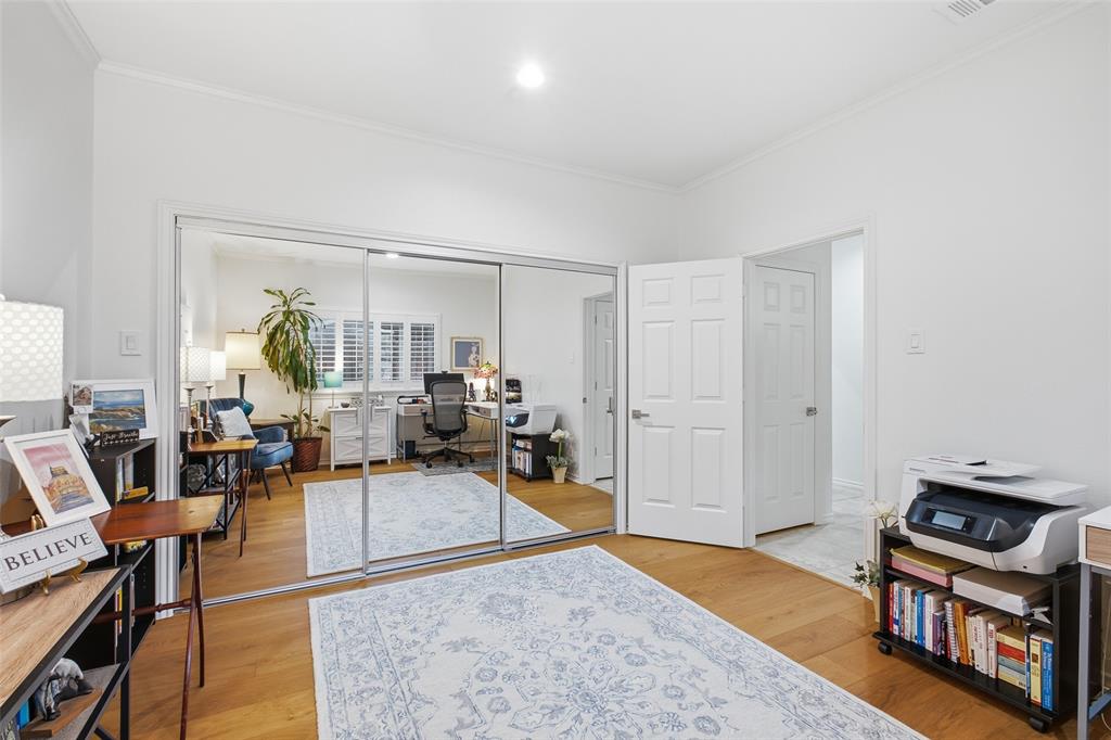 Mirrored sliding closet doors and warm wood floors in this versatile third bedroom.