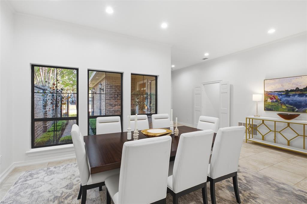 Formal dining framed by courtyard-facing windows—holiday dinners and birthday celebrations, all set.
