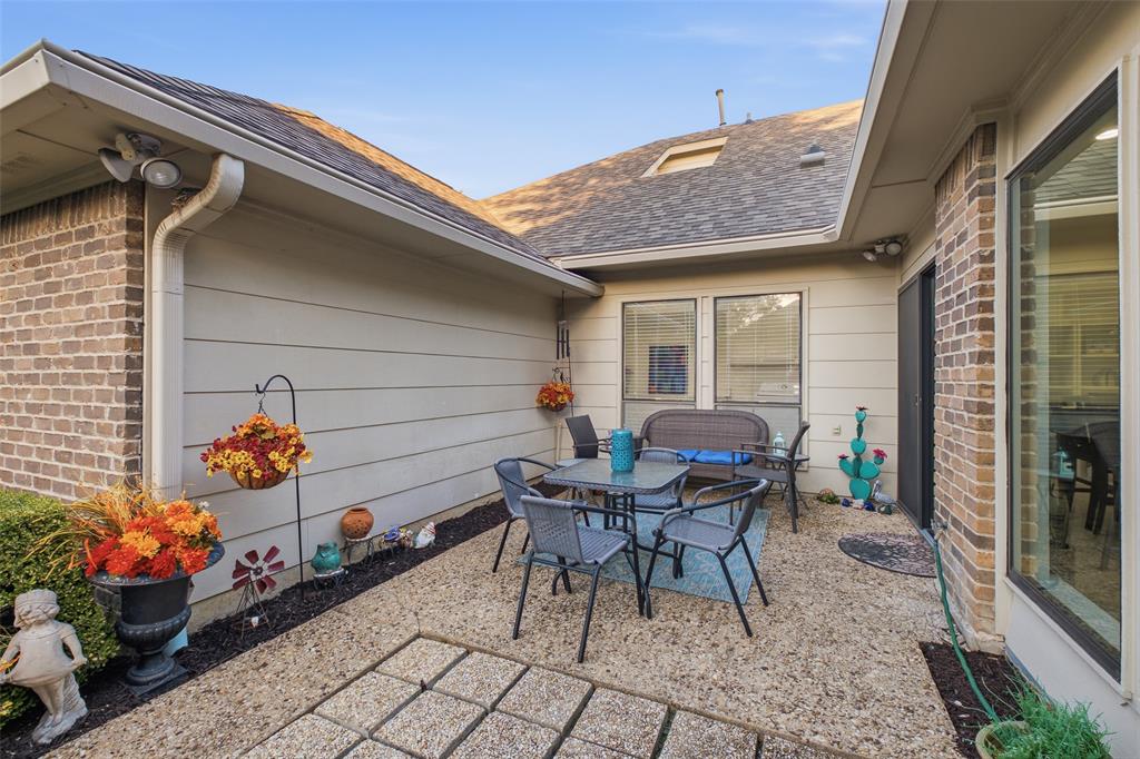 A private side courtyard ready for bistro dinners and outdoor living under the Texas sky.