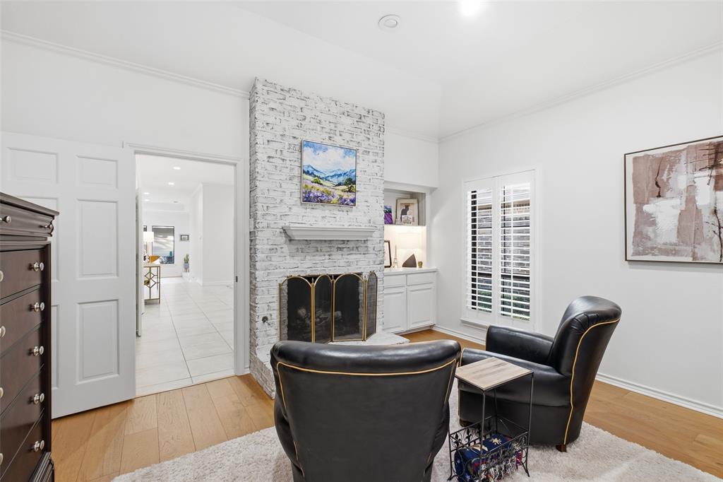 Curl up by your own bedroom fireplace, framed by built-in shelving and plantation shutters.