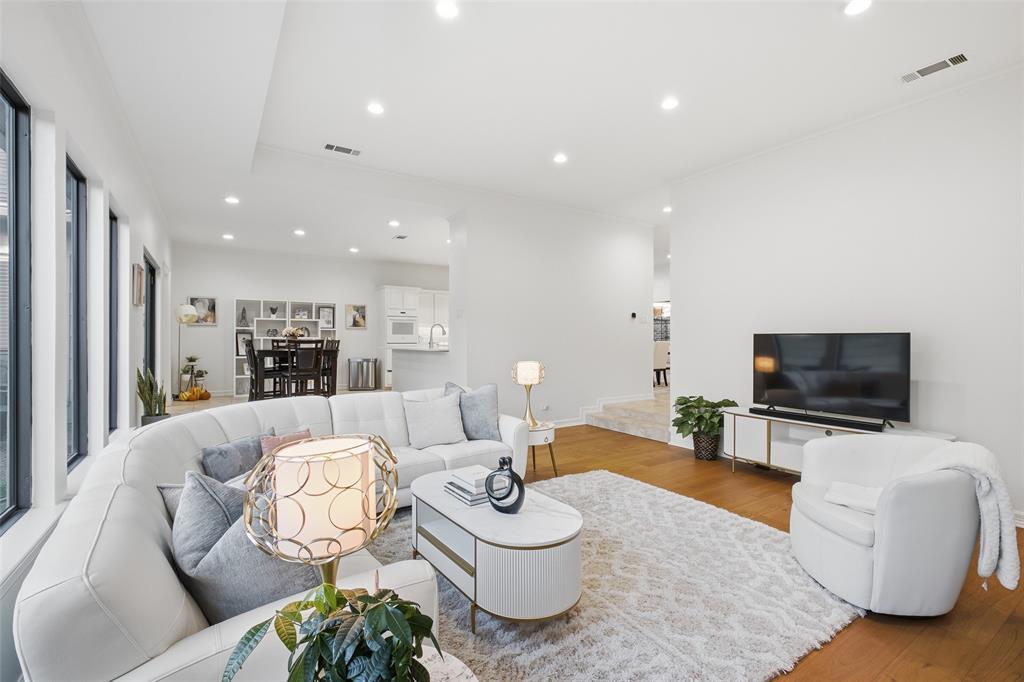 Recessed lighting, crown molding, and wide-plank floors make the living space feel crisp, airy, and move-in ready.