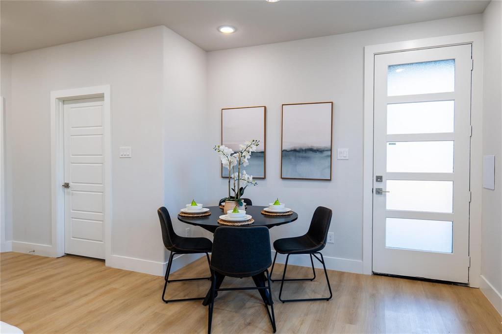 Wood-finish flooring, recessed lighting, and a contemporary entry door featuring frosted glass panels