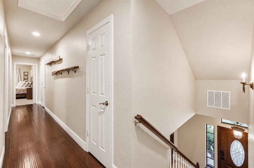 Hallway featuring wood-finish flooring, recessed lighting, and six-panel interior doors