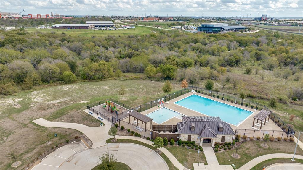 Community amenities featuring a swimming pool, wading pool, fenced playground, and covered pavilion structures