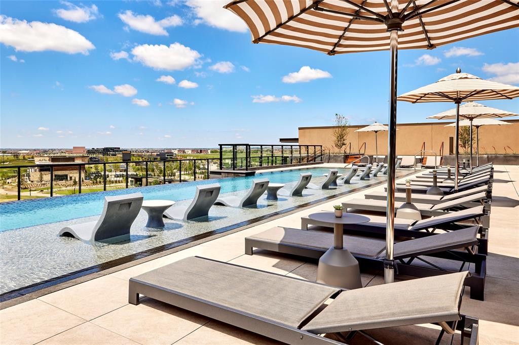 FRISCO PGA Rooftop infinity-edge pool featuring a Baja shelf, tiled deck surfacing, and metal perimeter railing FRISCO PGA Rooftop infinity-edge pool featuring a Baja shelf, tiled deck surfacing, and metal perimeter railing