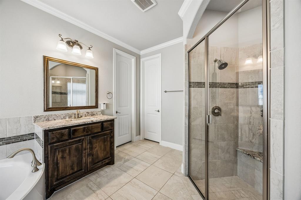 Dual vanities with tub and separate shower.