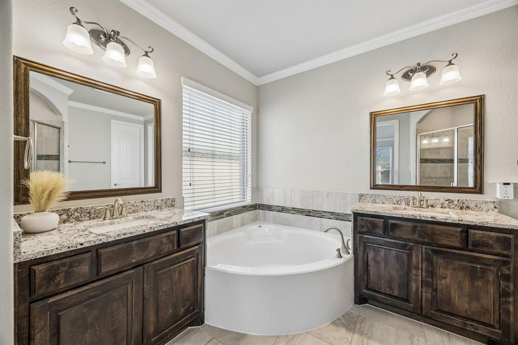 Dual vanities with tub and separate shower.