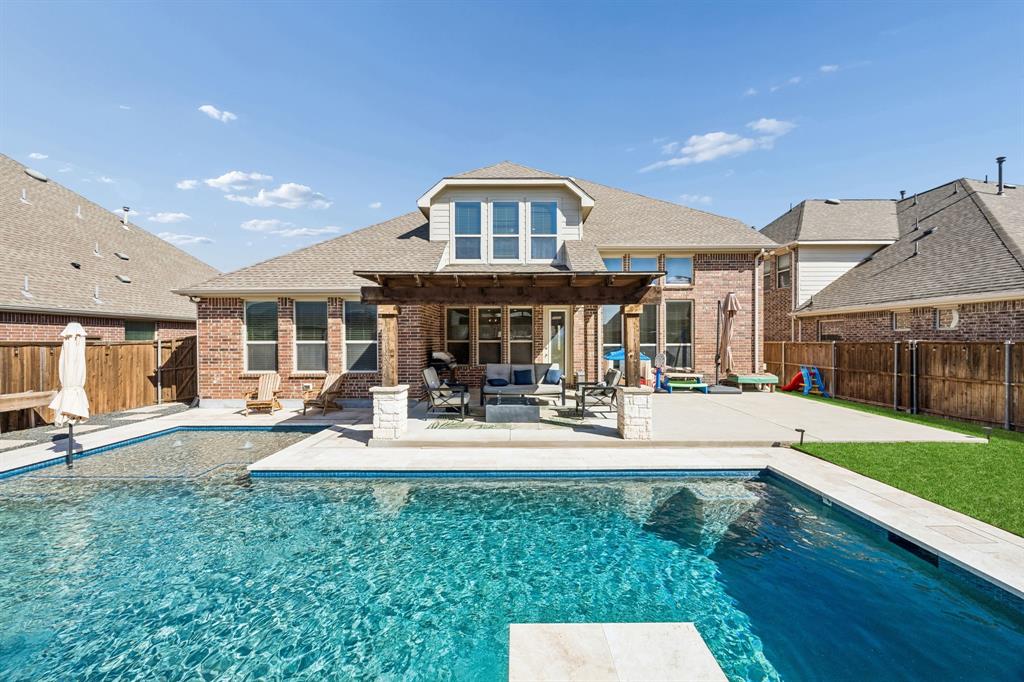 This backyard has it all. Pool with heater, per friendly turf and a 3 hole putting green!