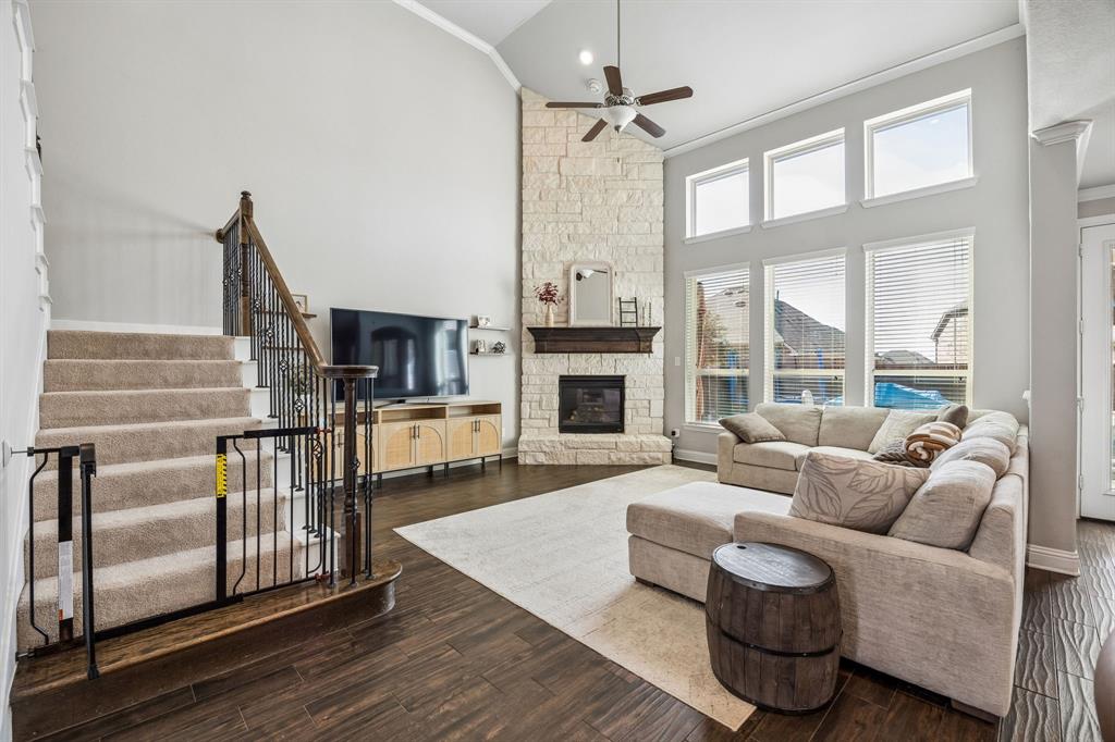 Family room open to the kitchen with floor to ceiling stone fireplace.