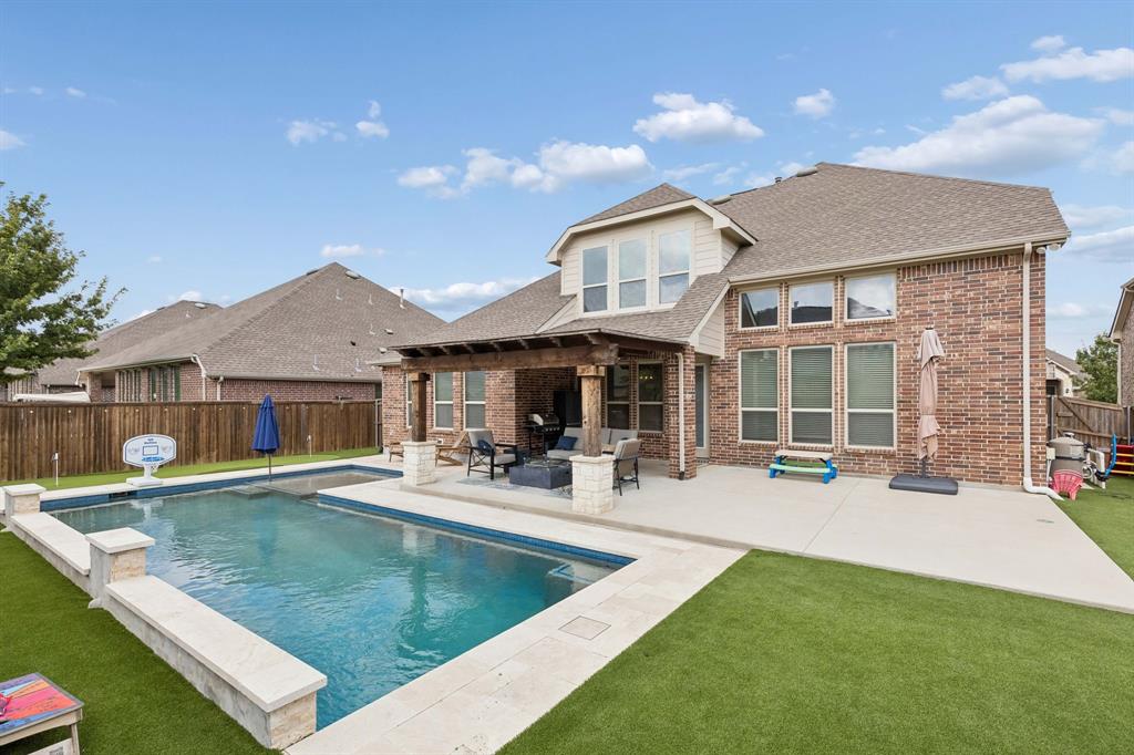 This backyard has it all. Pool with heater, per friendly turf and a 3 hole putting green!
