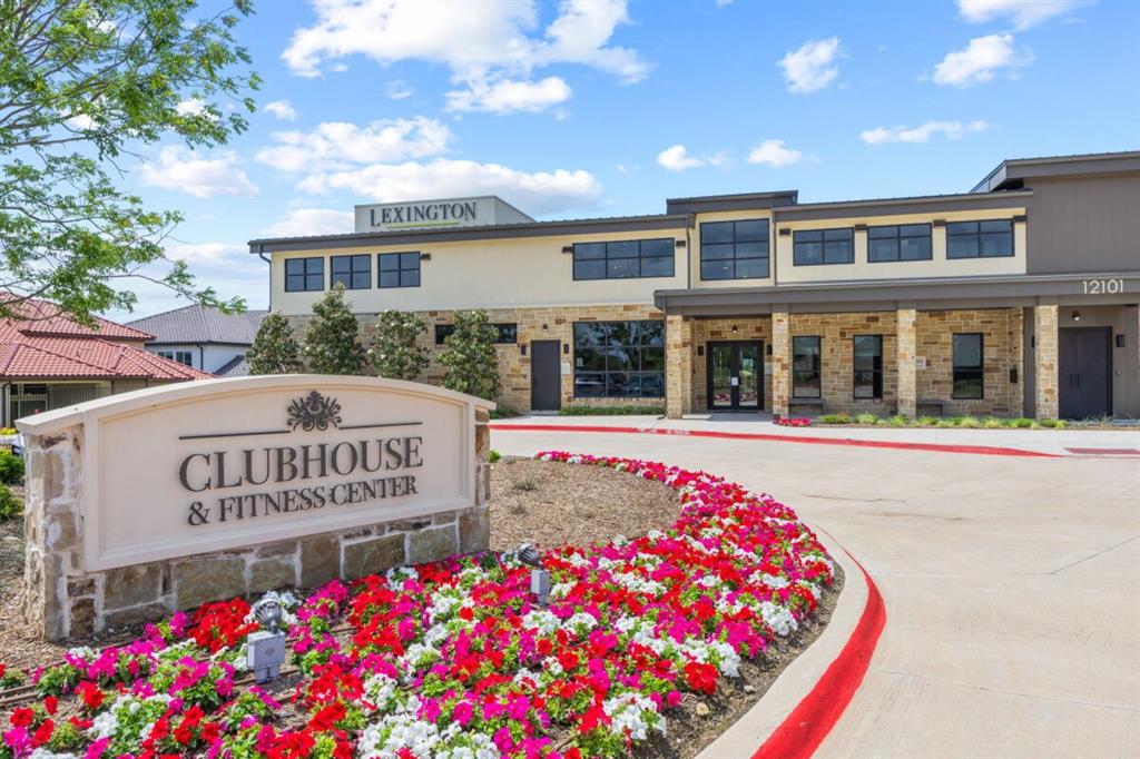 LEXINGTON Community Community clubhouse and fitness center featuring stone masonry accents, multi-pane windows, a covered entrance, and manicured landscaping