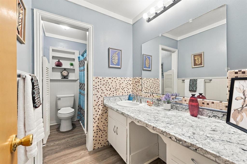 Full bathroom with large vanity and shower/ tub combo