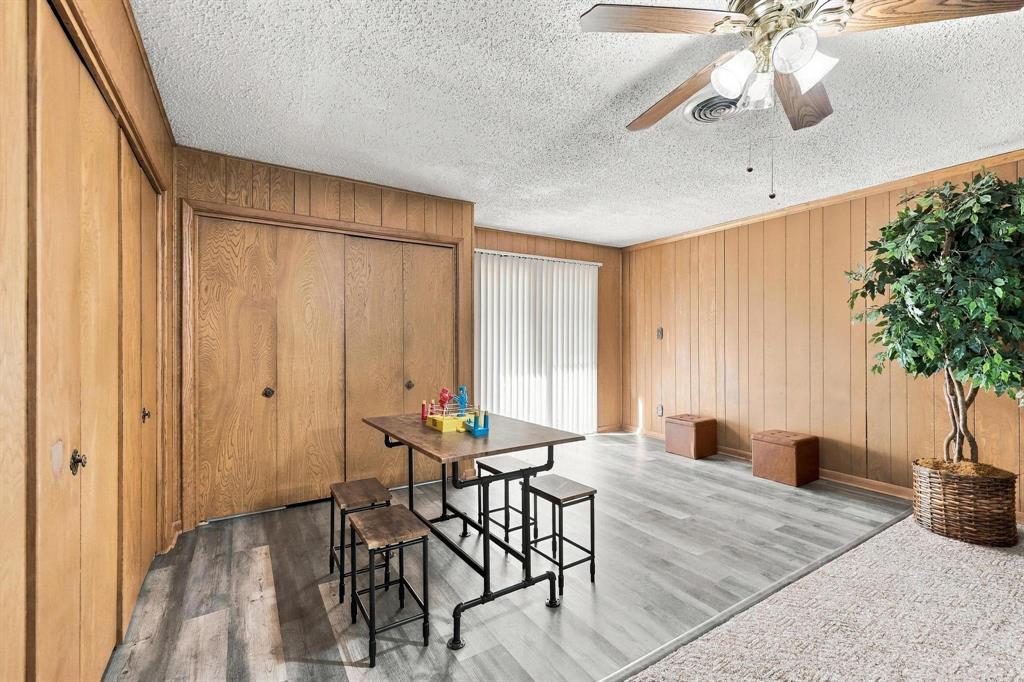 Dinning area with natural lighting and wood paneling accent wall