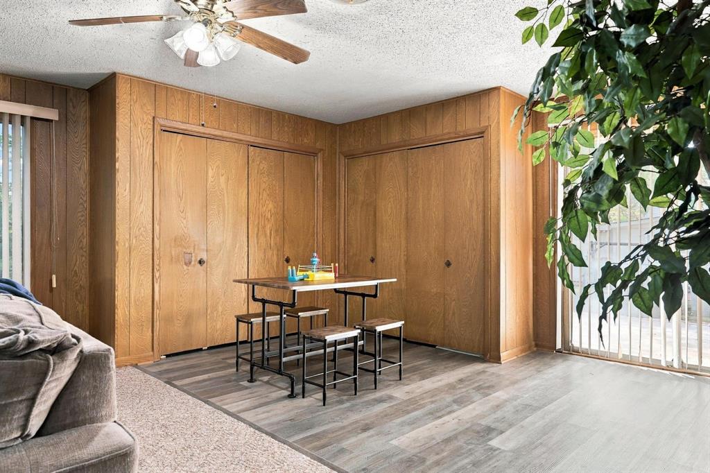 Dinning area with natural lighting and wood paneling accent wall