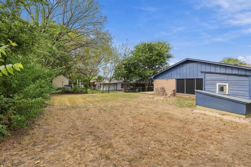 Spacious backyard featuring mature trees and fenced in yard