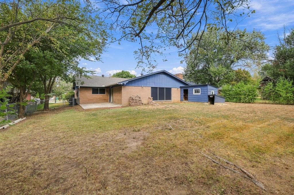 Spacious backyard featuring mature trees and fenced in yard