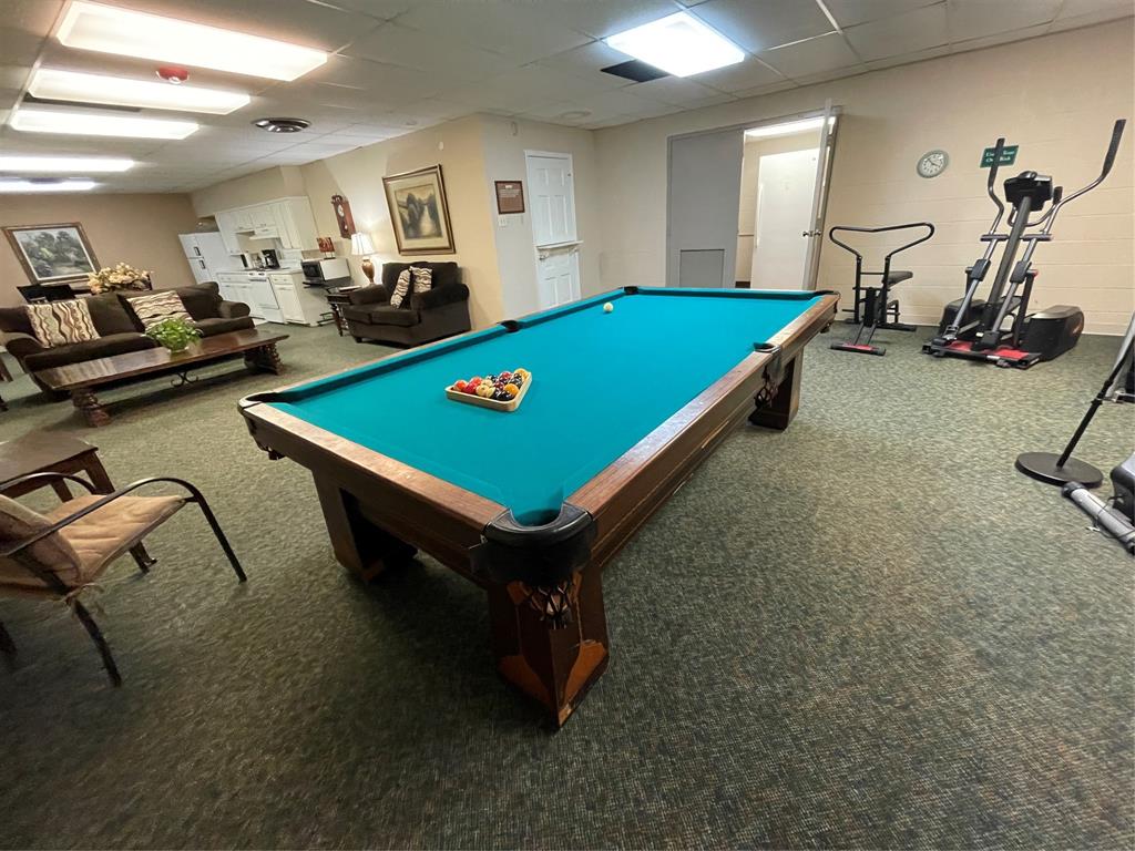basement game room with exercise equipment