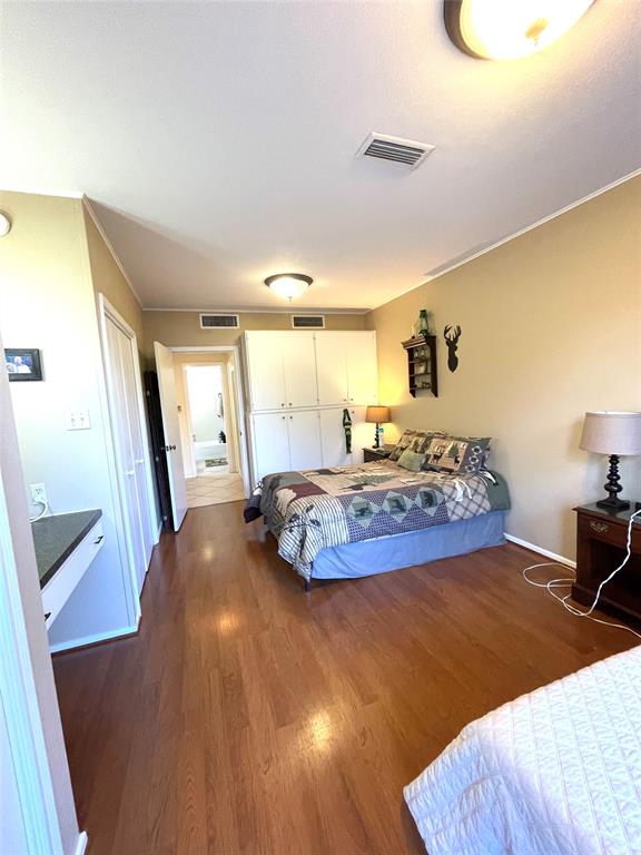Bedroom with wall of cabinents