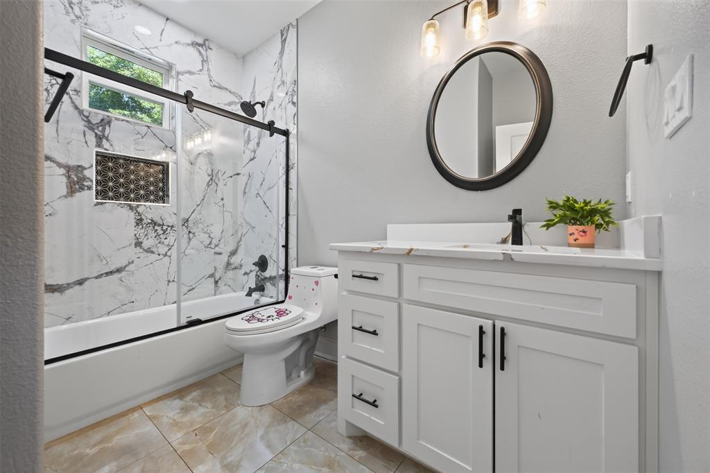 Second Full bathroom featuring a beautifully tiled tub and shower combo.