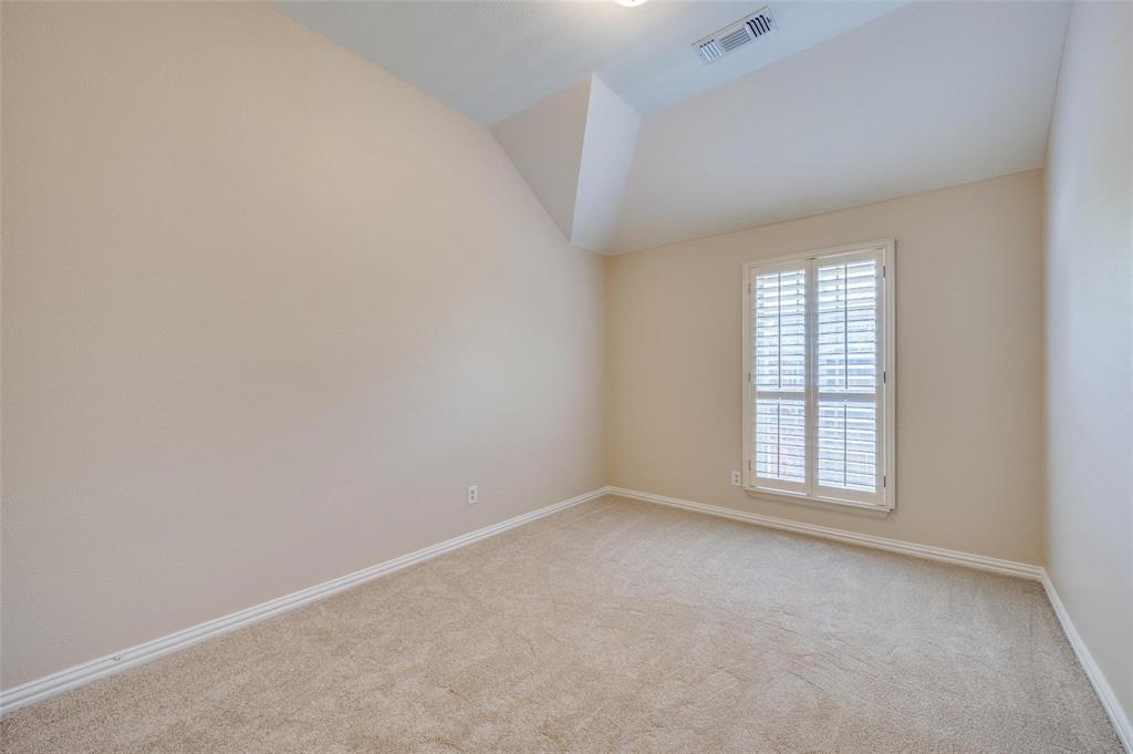 Vaulted ceiling featuring carpeted flooring and interior shutter window treatments