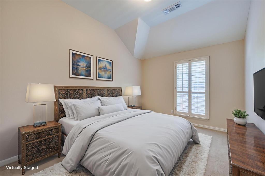 Vaulted ceiling, neutral wall tones, and plantation-style window shutters