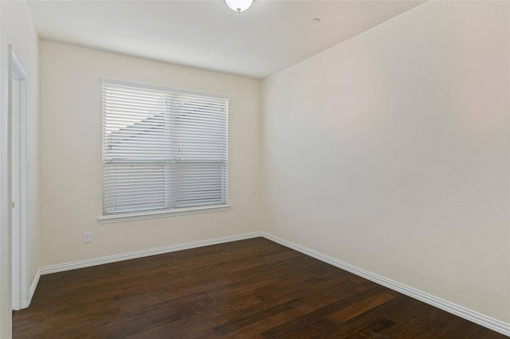Wood-finish flooring, neutral wall tones, and horizontal window blinds