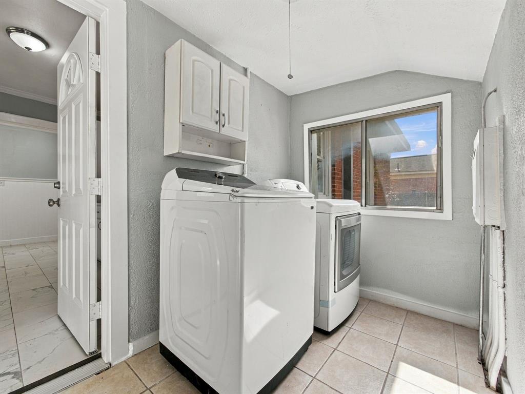 Separate utility room off the kitchen with door to backyard